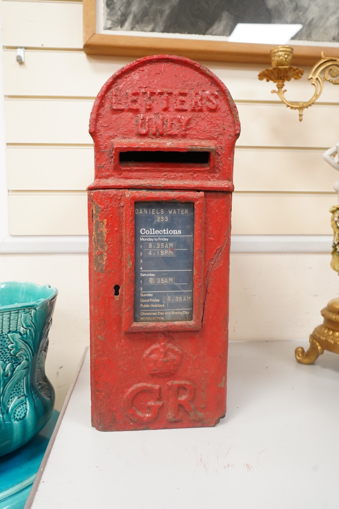 A George V red painted iron domed topped wall/post mounting post box, height 50.cm high x 19cm wide